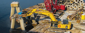 Komatsu excavator demolishing the I-10 Bridge in Pensacola, Florida