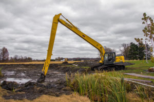 Long reach excavator in muddy area