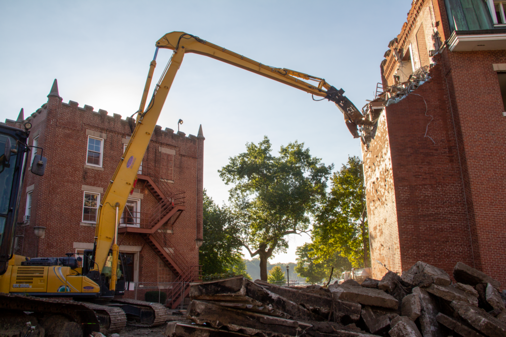 G&G Hauling and Excavating used a 60-foot high reach excavator to tear down the Main Barracks without disrupting campus life.
