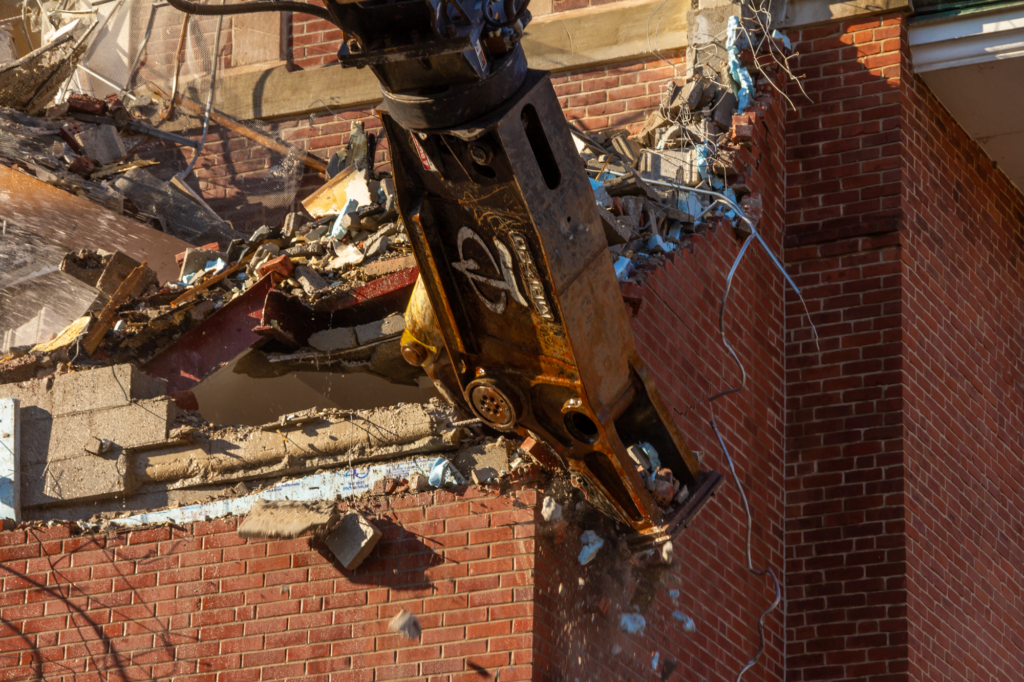 G&G Hauling and Excavating used a 60-foot high reach excavator to tear down the Main Barracks without disrupting campus life.