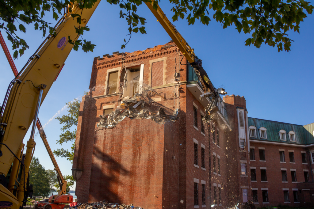 G&G Hauling and Excavating used a 60-foot high reach excavator to tear down the Main Barracks without disrupting campus life.